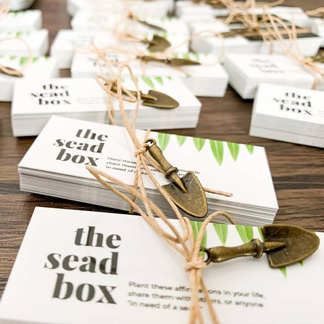 Piles of mini business cards with inspirational quotes by The Sead Box